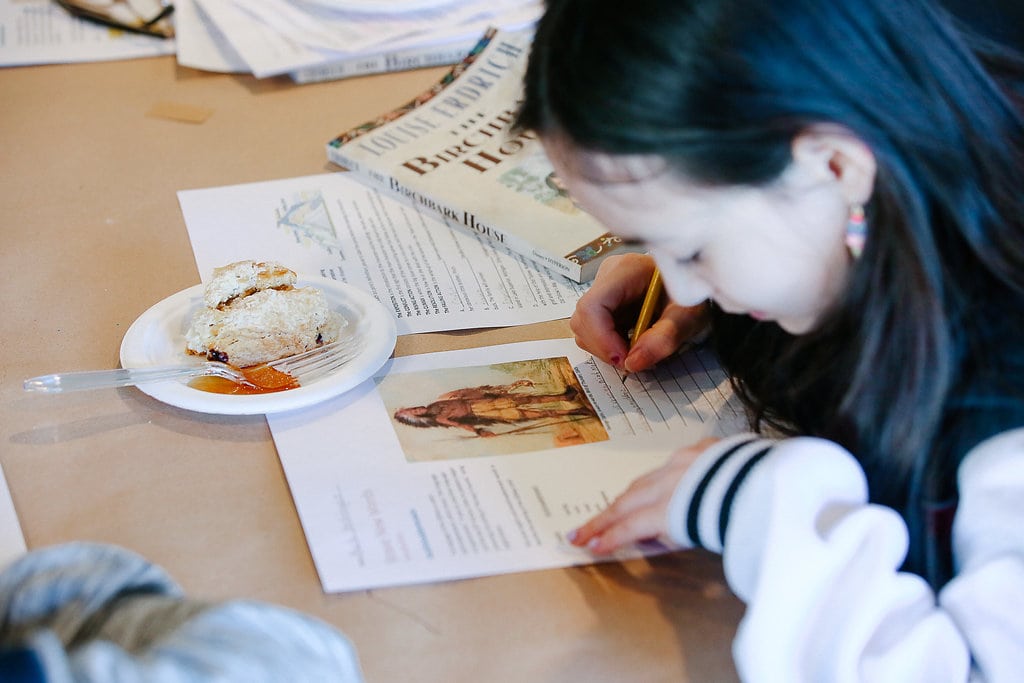 Child writing a vocabulary worksheet for THE BIRCHBARK HOUSE by Louise Erdrich - from LitWits Workshops