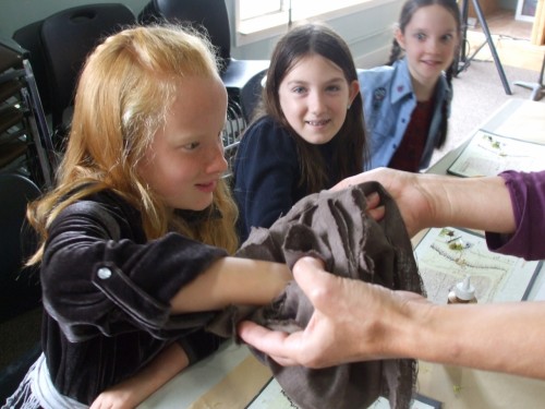 Kids exploring Gollum's treasures by feel, as he did - an activity from THE HOBBIT by JRR Tolkien - LitWits