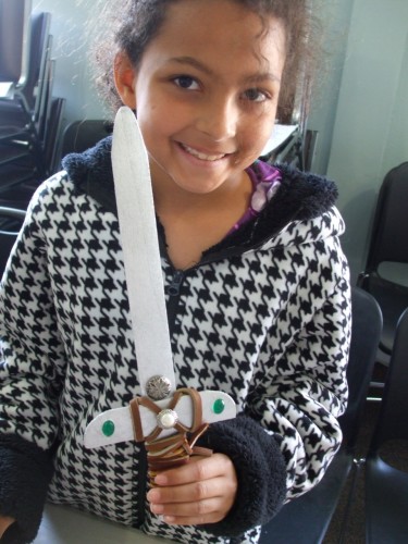 Child wielding a decorated wooden sword - craft for teaching THE HOBBIT by J.R.R. Tolkien, designed by LitWits Workshops