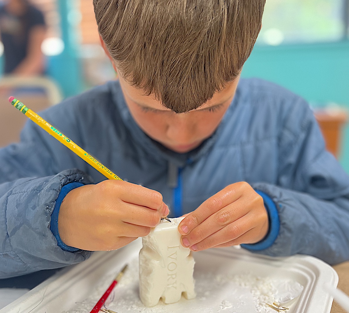 Child carving "Angel" from soap like Michelangelo - part of a LitWits activity idea for teaching FROM THE MIXED-UP FILES OF MRS. BASIL E. FRANKWEILER by E.L. Konigsburg